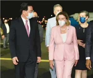  ?? ?? House Speaker Nancy Pelosi walks with Taiwan Foreign Minister Joseph Wu (left) after arriving in Taipei, Taiwan, on Tuesday night.