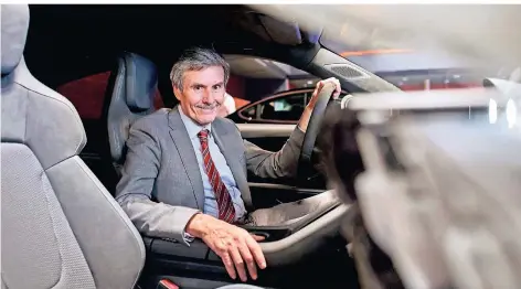  ?? FOTO: BERND THISSEN ?? Ferdinand Dudenhöffe­r sitzt beim Car-Symposium in Bochum in einem Modell des Porsche-Elektroaut­os Taycan.