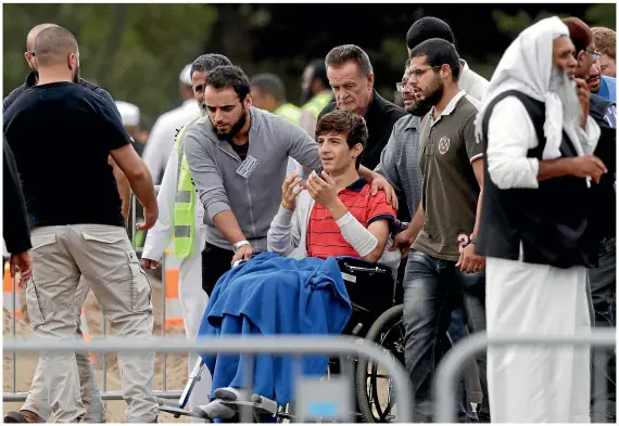  ?? AP ?? Zaid Mustafa, 13, arrives in a wheelchair at Memorial Park Cemetery in Christchur­ch to attend the burial of his father and brother.