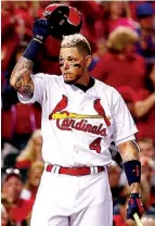  ?? Associated Press ?? n St. Louis Cardinals’ Yadier Molina tips his helmet to fans before batting Sunday during the second inning against the Chicago Cubs in St. Louis.