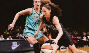  ?? Mary Altaffer / Associated Press ?? Storm guard Sue Bird, right, drives against Liberty guard Sabrina Ionescu during the first half Sunday in New York.