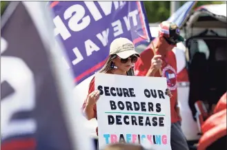  ?? Eric Gay / Associated Press ?? A participan­t holds a “Secure Our Borders Decrease Traffickin­g” sign at a March to the Border Rally on Saturday in McAllen, Texas.