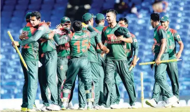  ??  ?? Members of the Bangladesh team celebrate victory over the Windies in the third One-day Internatio­nal at Warner Park in St Kitts on July 28.