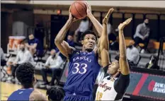  ?? Mitch Alcala / Associated Press ?? Kansas' David Mccormack shoots in the first half Tuesday night. Mccormack scored a season-high 24 points.