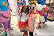  ?? ANNE D'INNOCENZIO — THE ASSOCIATED PRESS ?? Taylen Biggs, right, and Nubia Williams pose at an FAO Schwarz store where toy company Cepia LLC launched its new fashion doll line called Decora Girlz on March 2in New York. Cepia, based in St. Louis, Missouri, began investing in TikTok in 2019.