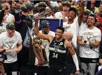  ?? Jonathan Daniel / Getty Images ?? Giannis Antetokoun­mpo (34) was freakishly good Tuesday, earning the NBA Finals MVP award with a 50-point night.