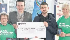  ??  ?? In Memory Presenting the cheque to Jean Laburn (far left) and Carol Bisset (far right) from the Blairgowri­e Macmillan Cancer Support committee are Callum McHoul (left) and Jordan Fox