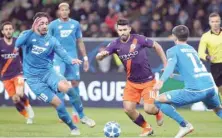  ?? — AFP ?? Hoffenheim’s Ishak Belfodil (left) and Florian Grillitsch (right) vie for the ball with Manchester City’s Sergio Aguero during the UEFA Champions League Group F match in Sinsheim, Germany.