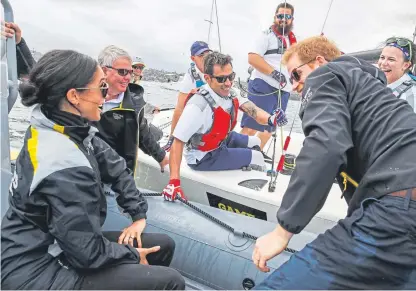  ?? Picture: PA. ?? The Duke and Duchess of Sussex talk to competitor­s taking part in a sailing event at the 2018 Invictus Games in Sydney Harbour.
