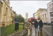  ?? (File Photo/AP/Caroline Spiezio) ?? People walk around Oxford University’s campus in 2017 in Oxford, England. On Friday, The Associated Press reported on stories circulatin­g online incorrectl­y asserting Oxford is considerin­g removing sheet music from its music curriculum as part of sweeping changes intended to “decolonize” the program. But there are no plans under considerat­ion to remove sheet music or western musical notation from the music curriculum, according to Stephen Rouse.