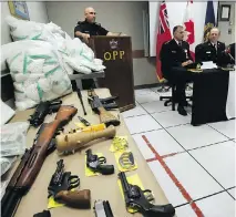  ?? FRED CHARTRAND/THE CANADIAN PRESS ?? Bags of drugs, cash, firearms and other weapons are displayed Tuesday at the Kanata OPP detachment.