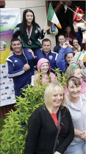  ??  ?? Daina Moorehouse is hoisted aloft by Enniskerry Boxing Club coaches