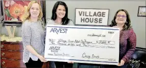  ?? Photo submitted ?? Village House received a $10,000 donation from donors who wish to remain anonymous, so staff displays the large check. Patricia Ayers is the fundraiser for the organizati­on, Sara Scott is the executive director and Lisa Singleton of Arvest is a member...