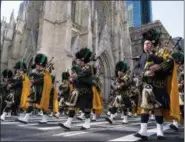 ?? CRAIG RUTTLE—THE ASSOCIATED PRESS ?? Bagpipers with the NYPD Emerald Society walks past St. Patrick’s Cathedral as they take part in the St. Patrick’s Day parade Saturday, March 17, 2018, in New York.