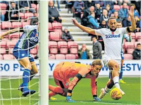  ??  ?? Crucial: Kemar Roofe capitalise­s on Christian Walton’s error to score Leeds’ winner