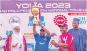  ?? ?? Adamawa State Governor , Umar Fintiri lifted the Governor’s Cup before presenting it to Murtala Laushi, the Patron of Jo Malcomines polo team, the overall winners of the 2023 polo tournament