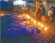  ?? /Foto: Agencia Reforma ?? Afuera del templo San Nicolás Tolentino, cololcaron los cuerpos de las víctimas con una veladora.