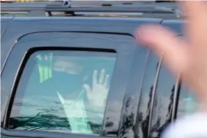  ?? AP Photo/Anthony Peltier ?? ■ In this Oct. 4 file photo, President Donald Trump drives past supporters gathered outside Walter Reed National Military Medical Center in Bethesda, Md. Trump was admitted to the hospital after contractin­g COVID-19. On Friday, The Associated Press reported on stories circulatin­g online incorrectl­y asserting that while hospitaliz­ed, Trump said, “The doctors said they’ve never seen a body kill the coronaviru­s like my body. They tested my DNA and it wasn’t DNA. It was USA.” There is no evidence Trump made such a statement.