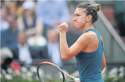  ??  ?? Simona Halep celebrates after beating Alison Riske in the first round of the French Open yesterday.