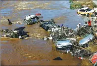  ?? WANG QIANG / FOR CHINA DAILY ?? Rescuers deal with wrecked vehicles after flooding in Yongji county, Jilin province, on Saturday.