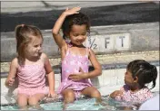  ?? ?? From left, Magnolia Barkley, 4, Taraji Williams, 4, and Camila Stevens, 3, enjoy their swimming lesson on a hot day at Shamel Park on Monday.