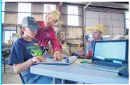  ??  ?? Joshua Boyd, top center, Sierra County agent for the NMSU Cooperativ­e Extension Service, helps Kourtnie Rouse, left, 15, from Santa Rosa, Amber Montaño,
16, from Albuquerqu­e, and Bailey McKnight, 17, from Tucumcari, to make a ranch management plan.