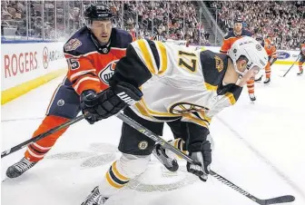  ?? JASON FRANSON/POSTMEDIA ?? Boston Bruins’ Ryan Donato is chased by Edmonton Oilers’ Evan Bouchard during NHL action in Edmonton, Oct. 18, 2018. —