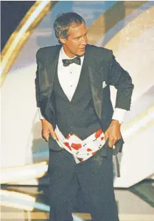  ?? Reed Saxon, AP file ?? Host Chevy Chase pulls up his pants at the 60th annual Oscars ceremony in Los Angeles after “mooning” the crowd.