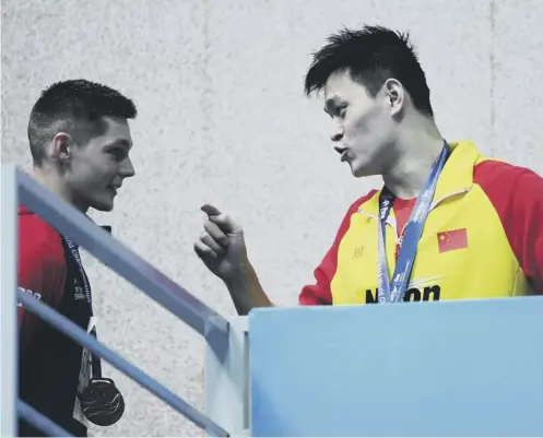  ??  ?? 0 China’s Sun Yang, right, remonstrat­es with Duncan Scott after the Scot’s world championsh­ips protest over Sun’s doping case.