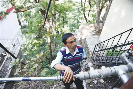  ?? PHOTOS BY SAUMYA KHANDELWAL / THE NEW YORK TIMES ?? Inder Singh, a “key man” who opens and closes the valves that supply water to each neighborho­od, works June 7 in Shimla, India. The “key men” of Shimla were subjected to so much wrath during a drought that they were given police protection.