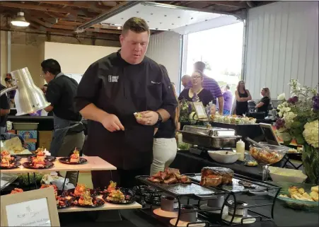  ?? BARRY TAGLIEBER — FOR MEDIANEWS GROUP ?? Chef Shane Cash prepares food for people to sample at Bite for the Fight at the Kimberton Fairground­s.