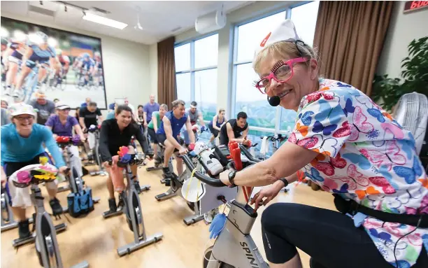  ??  ?? Having fun is a given in popular classes, even at 6 a.m. Brenda Klochnyk shows how it’s done at the Athletic Club, where a medical theme celebrates two nurses’ retirement­s.