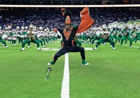  ?? PHOTOS BY MICHAEL WYKE/AP ?? The Florida A&M University Marching 100 band performs during the 2023 National Battle of the Bands at NRG Stadium in Houston on Aug. 26.