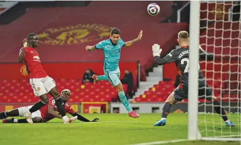  ?? (Reuters) ?? Liverpool’s Roberto Firmino (centre) scores against Manchester United in the Premier League at Old Trafford, Manchester, on Thursday night.