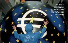  ??  ?? An artist celebrates the birth of the new euro currency