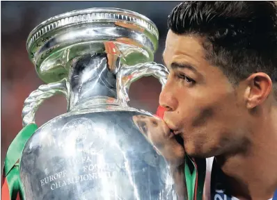  ??  ?? Portugal’s Cristiano Ronaldo kisses the trophy at the end of the Euro 2016 final between Portugal and France earlier this month. At the moment he’s the superstar of sponsors, says Patrick Nally.