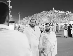  ??  ?? Muslim pilgrims pose for a photo in front of Mount Arafat, on the eve of Arafat Day which is the climax of the Hajj pilgrimage. — AFP photo