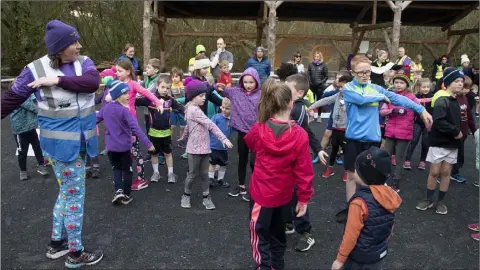  ??  ?? Neomie Van Der Blaike put the children through their warm-up exercises before the start of the Junior Park Run in the Irish National Heritage Park.