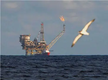  ?? — Reuters ?? Rising production: A seagull flies in front of an oil platform in the Bouri Oilfield off Libya. Higher Opec production in September weighed on oil futures this week.