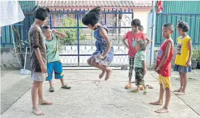  ??  ?? Children react with enthusiasm outside the constructi­on site of their new home in a sub-district of Mae Tao. The children live, play, study and grow together in their current home in Mae Sot district which has become cramped. They also do not have...