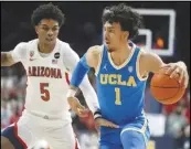  ?? Associated Press ?? UCLA guard Jules Bernard (1) drives past Arizona guard Justin Kier (5) during the first half on Thursday in Tucson, Ariz. Bernard led the Bruins with 15 points in a 76-66 loss to the Wildcats.