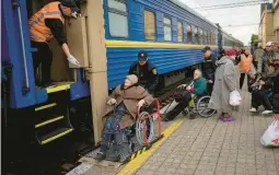  ?? FRANCISCO SECO/AP ?? Civilians fleeing from shelling board an evacuation train Sunday in Pokrovsk, eastern Ukraine. They described scenes of devastatio­n in their towns and villages.