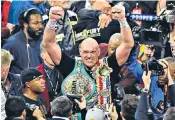  ??  ?? Tyson Fury, above, celebrates winning Saturday’s world heavyweigh­t title bout at the MGM Grand, Las Vegas. Below, Tyson and Paris Fury with their five children