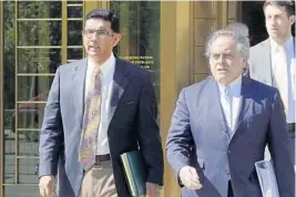  ?? AP/FILE ?? Dinesh D'Souza, left, is seen in a 2014 photo accompanie­d by his lawyer Benjamin Brafman leaving federal court in New York. D’Souza pleaded guilty to campaign finance fraud.