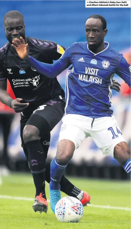  ??  ?? > Charlton Athletic’s Naby Sarr (left) and Albert Adomah battle for the ball