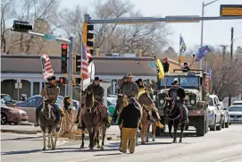  ??  ?? Members of Cowboys for Trump arrive at the state Capitol on Wednesday.