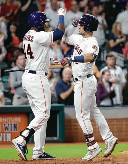  ?? Karen Warren / Staff photograph­er ?? The instigator­s of the Astros’ sixth-inning power display meet at home plate after Alex Bregman, right, homered to left, with Yordan Alvarez to follow with a 454-foot blast to center.