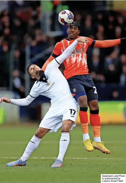  ?? ?? Swansea’s Joel Piroe is outmuscled by Luton’s Amari’i Bell