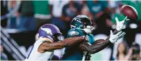  ?? DERIK HAMILTON/AP ?? Eagles wide receiver A.J. Brown misses this throw from Jalen Hurts in front of Minnesota Vikings cornerback Akayleb Evans on Thursday night at Lincoln Financial Field.