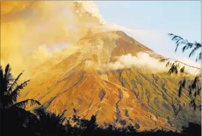  ?? Bullit Marquez ?? The Associated Press The Mount Mayon volcano spews lava in another eruption as seen Wednesday from Legazpi, Philippine­s. Lava fountainin­g from the Philippine­s’ most active volcano has flowed up to 1.86 miles from the crater in an increasing­ly dangerous...